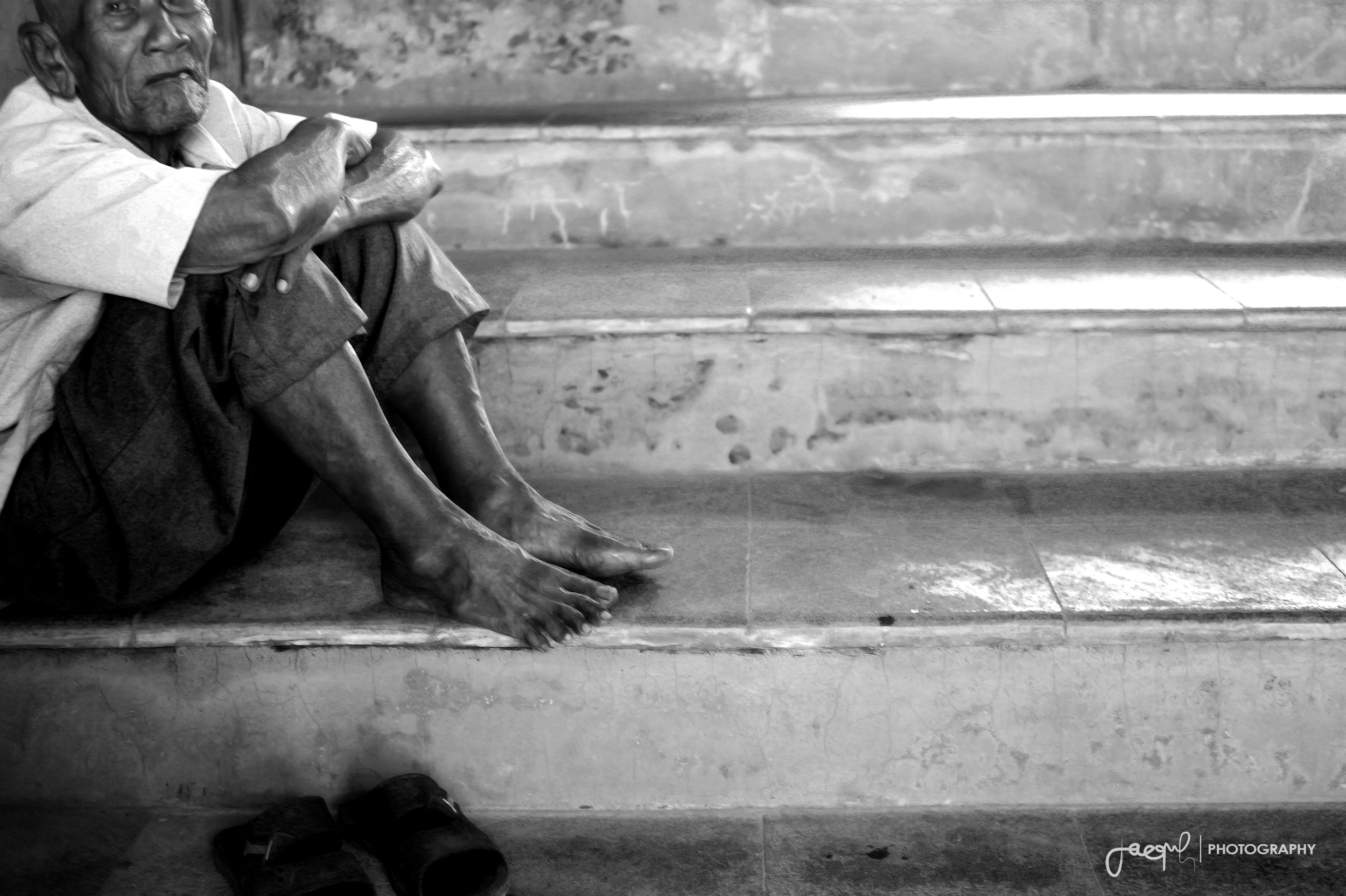  In 2013 I got the opportunity to travel to Indonesia. This photograph was taken at the Sultan's Bath in Jogjakarta. This beautiful man was sitting on it's steps simply watching all us tourists walk by.&nbsp; 
